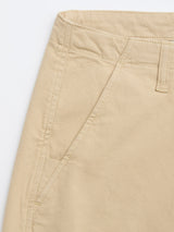 Close-up of the BGpalco Rodas Pants by Blue de Gênes in pale khaki, featuring a front pocket, belt loop, and visible stitching. These relaxed regular fit chinos provide timeless comfort and class against a white backdrop.