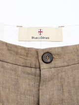 Close-up of the waistband of grey melange BGpalco Lin Pants by Blue de Gênes, showing a black button and a “Blue de Gênes” label with a red and white shield logo above the brand name.