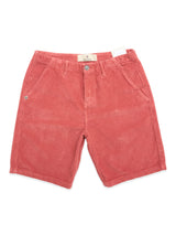 The BGfloyd Cord Shorts - Coral by Blue de Gênes are loose-fit red corduroy shorts with side pockets, button and zipper closure, and a small white waistband label, shown flat on a white background.