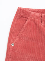 Close-up of the top half of Blue de Gênes BGfloyd Cord Shorts in coral, featuring an elastic waistband, side pocket, and a small shield-with-cross patch near the pocket.