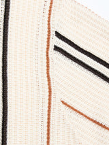Close-up of the BGwalter S/S Cardigan - Chalk by Blue de Gênes, a textured cream 100% cotton cardigan featuring black and brown vertical and diagonal stripes, waffle-like pattern, and visible stitching for a cozy lace knit look.