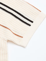 Close-up of the Blue de Gênes BGwalter S/S Cardigan in Chalk, a cream-colored 100% cotton knit with brown and black stripes near the sleeve hem and soft textured fabric finished with a solid cream cuff for a refined look.