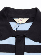 Close-up of the Blue de Gênes BGwally Stripe Polo - Dark Navy, featuring wide navy and light blue stripes, a navy collar, and a tag with the brand name and shield emblem.