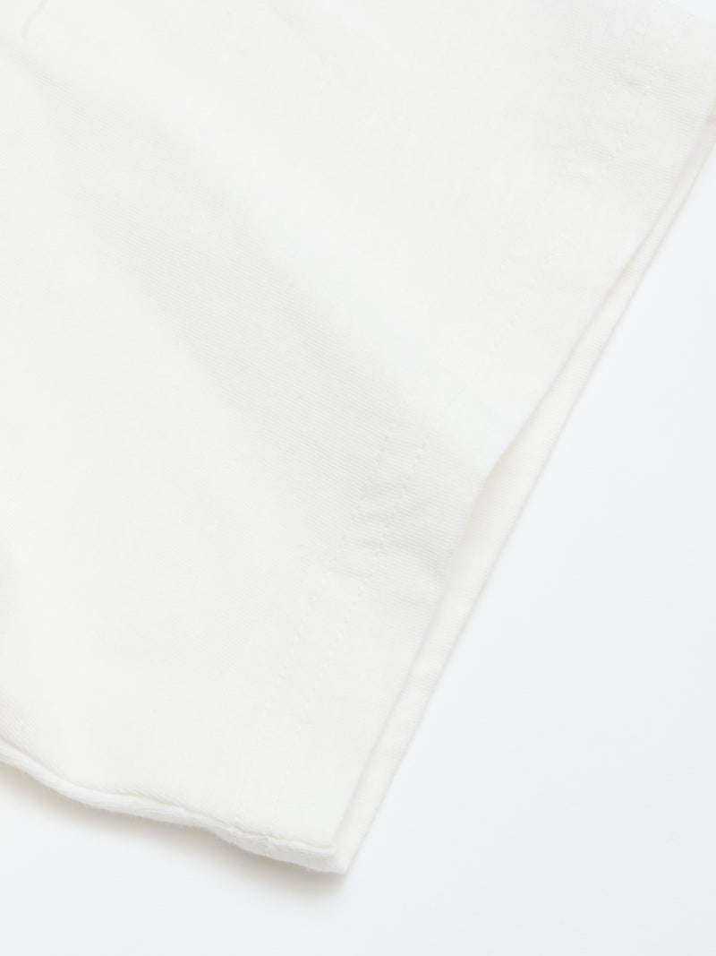 A close-up of the BGoscar T-Shirt - Snow Fall by Blue de Gênes highlights its soft 100% cotton fabric and neat edge stitching, showcasing exceptional quality.