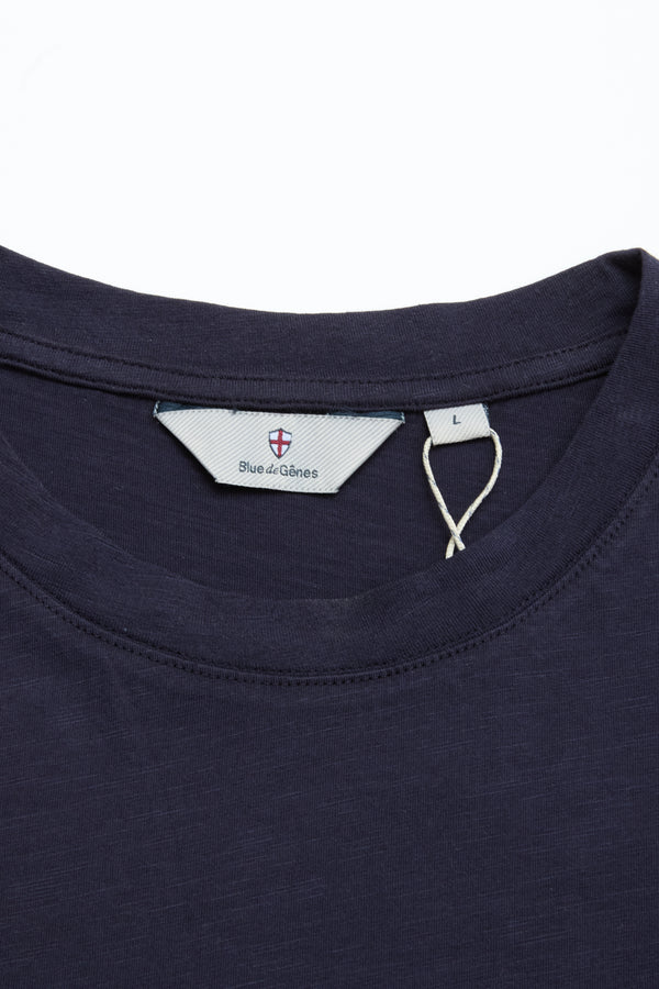 Close-up of the BGoscar T-Shirt in Dark Navy by Blue de Gênes, showing its crewneck, visible brand label, and size L tag on a plain white background. Crafted from 100% cotton.