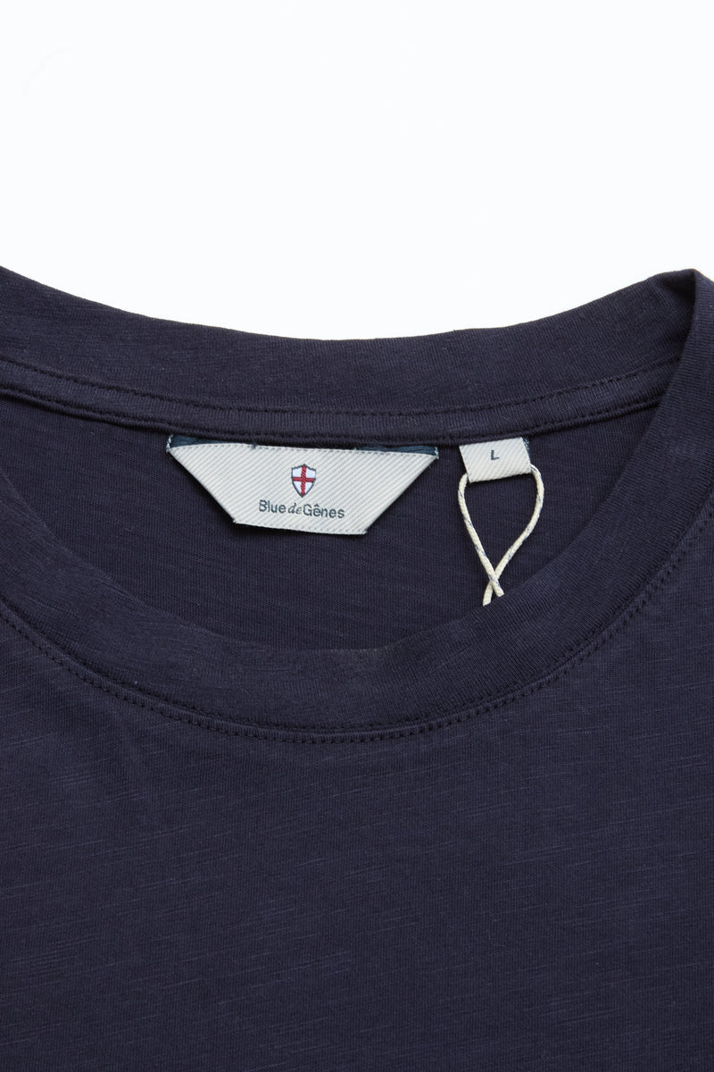 Close-up of the BGoscar T-Shirt in Dark Navy by Blue de Gênes, showing its crewneck, visible brand label, and size L tag on a plain white background. Crafted from 100% cotton.