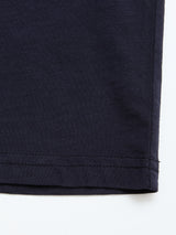 Close-up of the hem on a Blue de Gênes BGoscar T-Shirt in dark navy 100% cotton, showing parallel stitching near the edge against a white background.