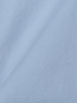 Close-up of the BGmenzino Vecchio Shorts in Blue Fog by Blue de Gênes, highlighting their light blue hue, soft cotton texture, and fine diagonal weave with a gentle fold across the fabric.