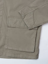 Close-up of the Blue de Gênes BGhunter Vecchio Jacket in Shadow Green, highlighting a large front pocket, part of the sleeve, and visible stitching on the pocket, sleeve, and hem.