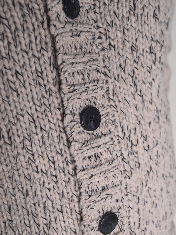 Close-up of the Blue de Gênes Sakura Knit Cardigan - Stone, a chunky wool blend cardigan in beige and gray with a ribbed button band, four black buttons, and a textured knit pattern.