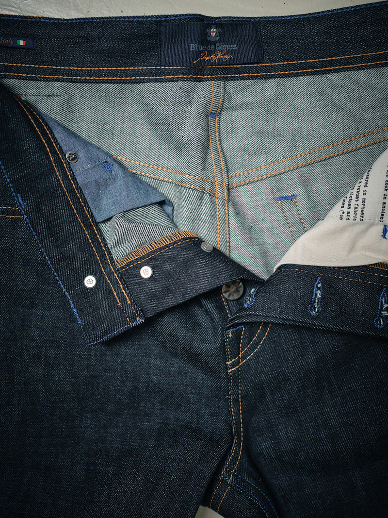 Close-up of Blue de Gênes Giacomo Selvedge V2 Jeans in raw, dark blue denim, with the fly open to reveal inside fabric, stitching, button, and pocket lining.